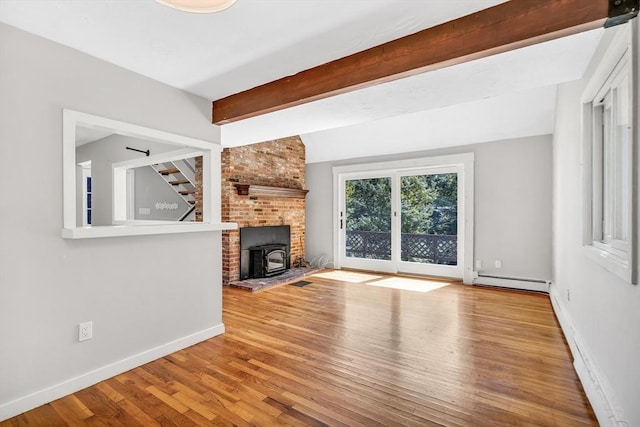 2 Clover Hill Rd, Acton, MA 01720 - unfurnished living room featuring a baseboard heating unit, a wood stove, and wood finished floors