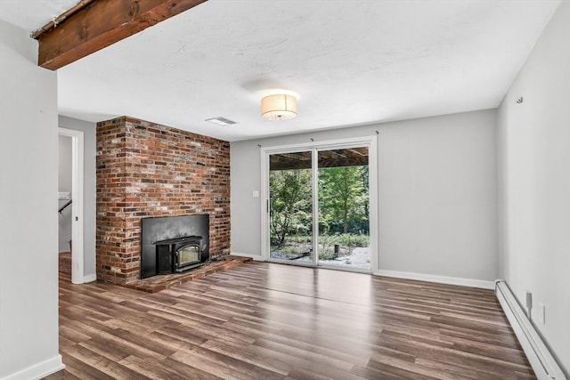 2 Clover Hill Rd, Acton, MA 01720 - unfurnished living room featuring a baseboard heating unit, a wood stove, and wood finished floors