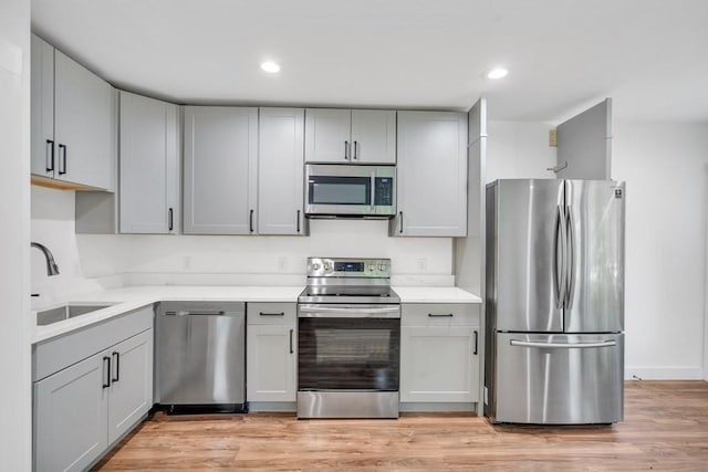 2 Clover Hill Rd, Acton, MA 01720 - kitchen with stainless steel appliances, gray cabinets, light countertops, light wood-style floors, and recessed lighting
