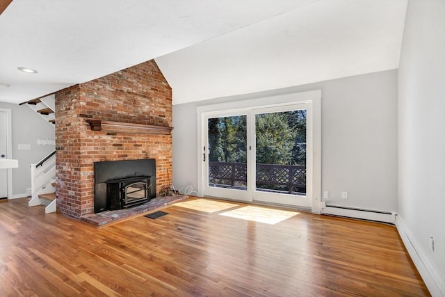 2 Clover Hill Rd, Acton, MA 01720 - unfurnished living room with a baseboard radiator, stairway, wood finished floors, a wood stove, and lofted ceiling