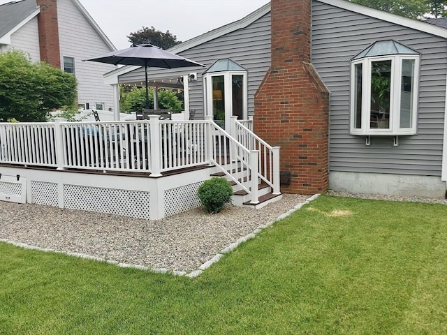 214 Fisher St, Walpole, MA 02081 - rear view of house featuring a deck, a lawn, and a chimney