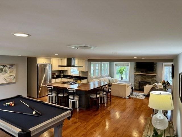 214 Fisher St, Walpole, MA 02081 - rec room with wood finished floors, a stone fireplace, pool table, and recessed lighting
