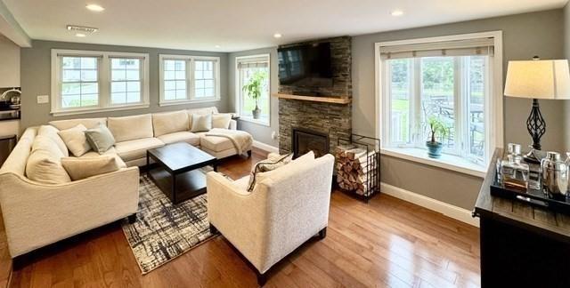 214 Fisher St, Walpole, MA 02081 - living room with plenty of natural light, wood finished floors, a fireplace, and recessed lighting