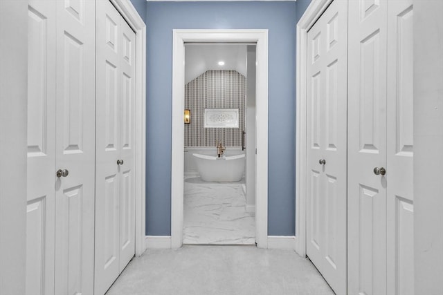 10 Highcroft Way Unit 10, Hopkinton, MA 01748 - full bathroom featuring a closet, marble look tiles, baseboards, a freestanding bath, and lofted ceiling