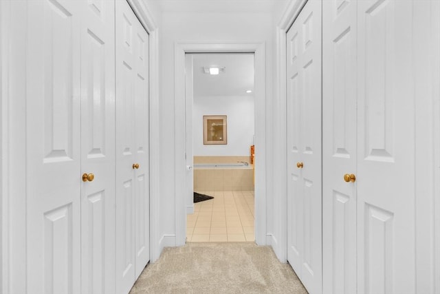10 Highcroft Way Unit 10, Hopkinton, MA 01748 - corridor featuring light tile patterned floors and light carpet