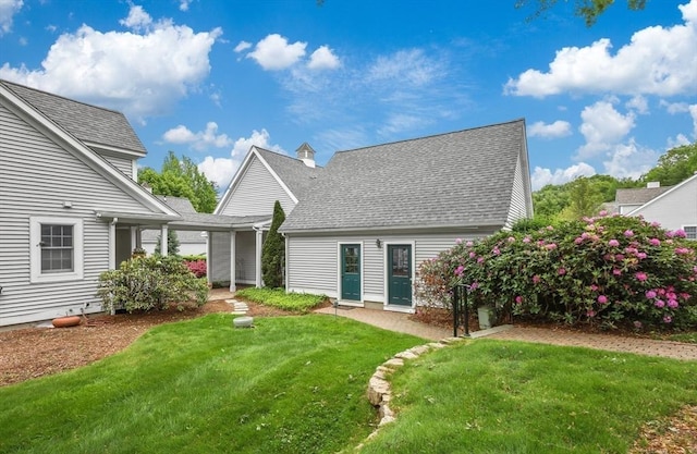 10 Highcroft Way Unit 10, Hopkinton, MA 01748 - rear view of house with a lawn and roof with shingles