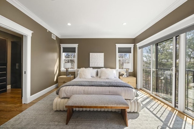 bedroom featuring visible vents, crown molding, baseboards, wood finished floors, and access to outside