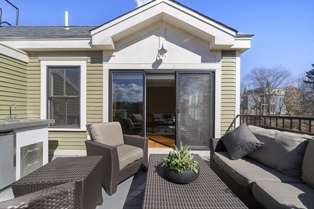 wooden deck featuring an outdoor hangout area and a sink