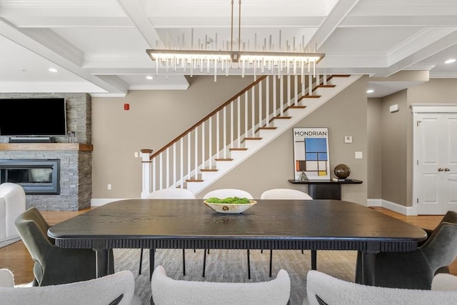 dining area with coffered ceiling, stairs, baseboards, and wood finished floors