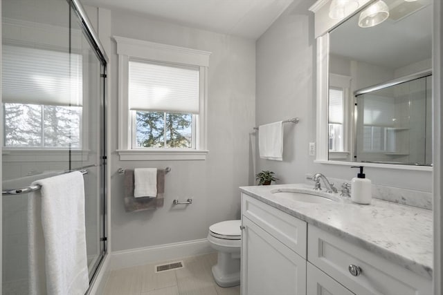 full bathroom featuring visible vents, a shower stall, vanity, and toilet