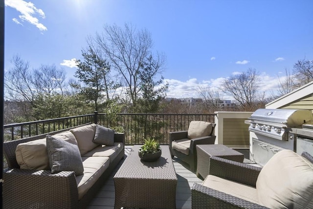 deck featuring an outdoor living space, grilling area, and exterior kitchen