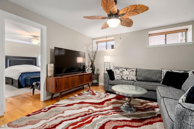 living area featuring light wood finished floors and a ceiling fan