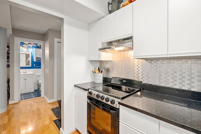 kitchen with range with electric stovetop, light wood finished floors, backsplash, white cabinets, and under cabinet range hood