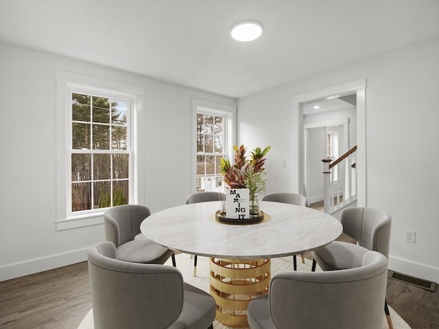 dining space with wood-type flooring