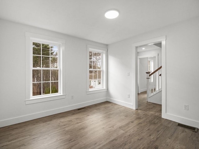 empty room with dark hardwood / wood-style floors