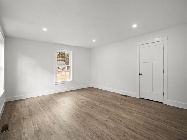 unfurnished room featuring dark hardwood / wood-style flooring