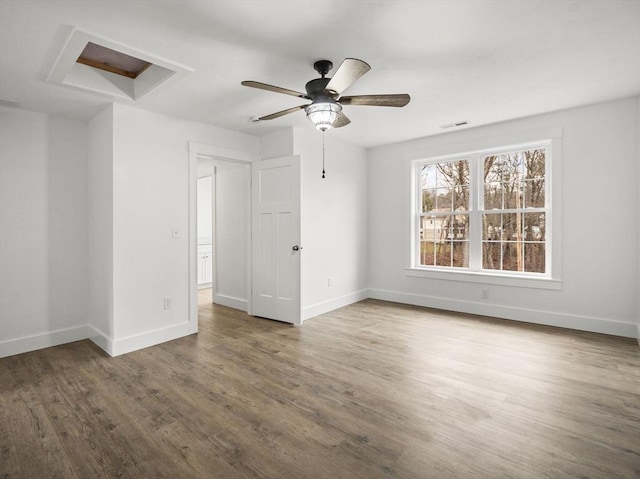 spare room with hardwood / wood-style floors and ceiling fan