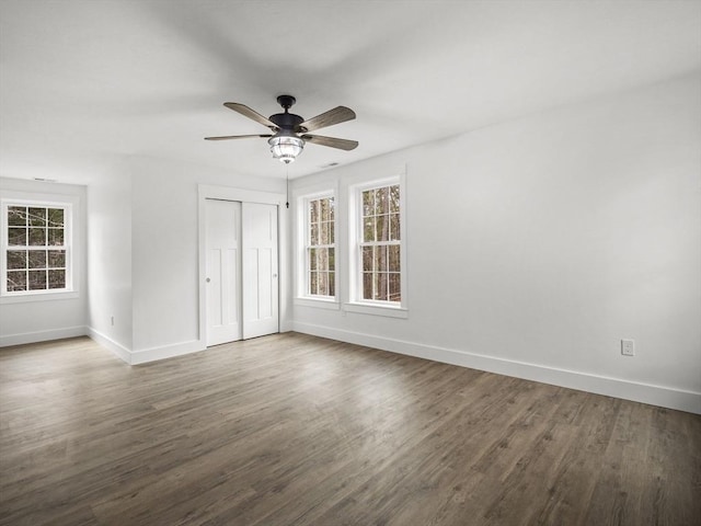 unfurnished room featuring dark hardwood / wood-style floors and ceiling fan