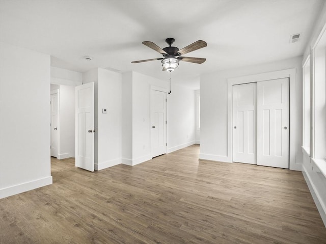 unfurnished bedroom with ceiling fan and hardwood / wood-style floors