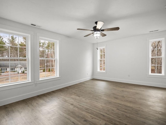 unfurnished room with dark hardwood / wood-style floors and ceiling fan