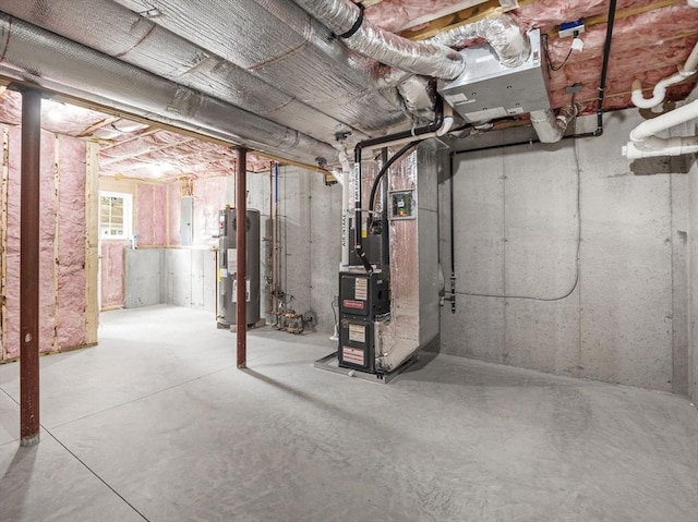 basement featuring heating unit and water heater