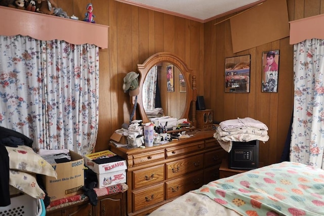 bedroom with wooden walls and ornamental molding