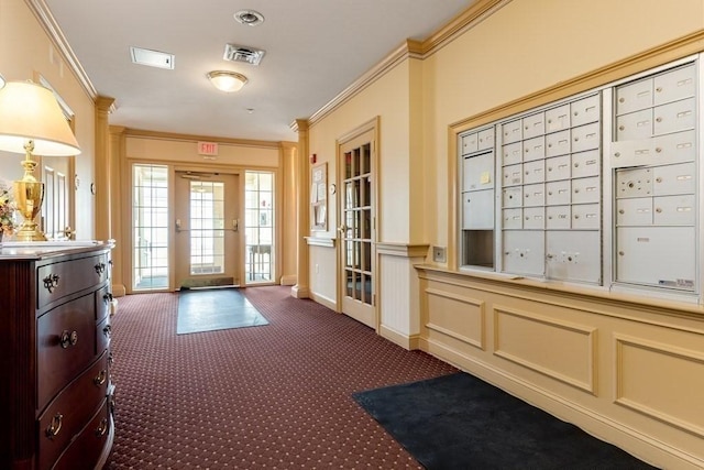 interior space with ornamental molding, mail boxes, and dark colored carpet