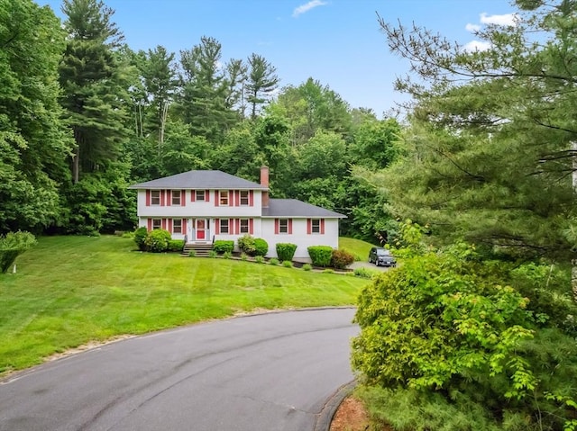 32 Berkeley, Pelham, NH 03076 - colonial house with driveway, a wooded view, a front lawn, and a chimney
