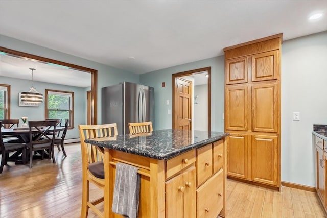 32 Berkeley, Pelham, NH 03076 - kitchen with freestanding refrigerator, light wood finished floors, dark stone countertops, a center island, and recessed lighting