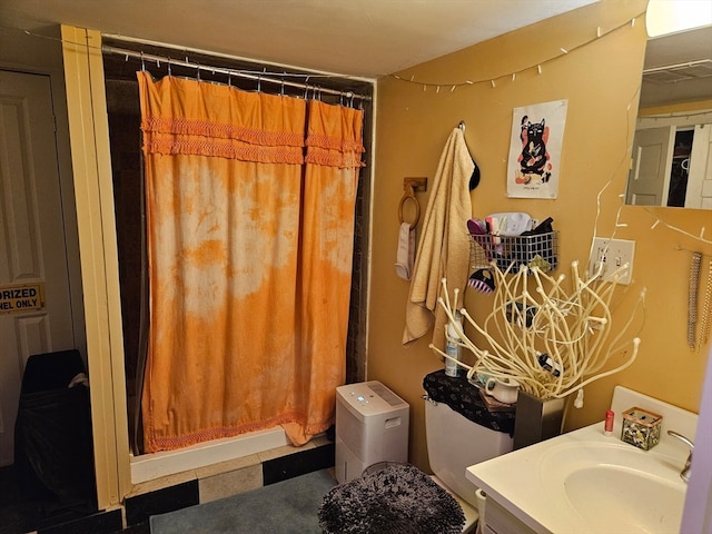 bathroom featuring vanity and a shower with shower curtain