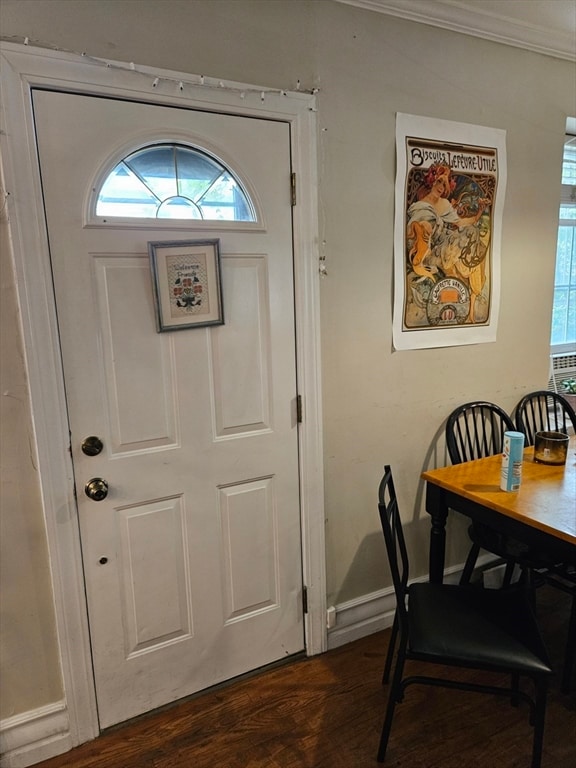 interior space featuring crown molding and dark hardwood / wood-style flooring