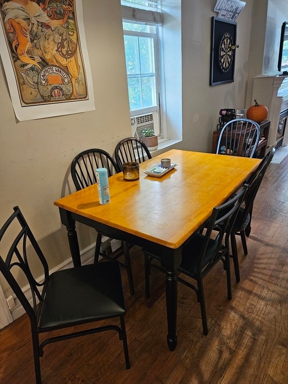 dining space featuring cooling unit and hardwood / wood-style floors