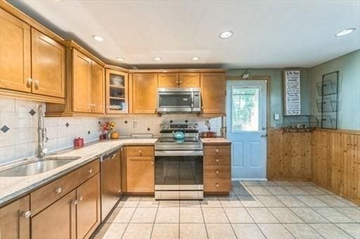 22 Sylvia Ave, Brockton, MA 02301 - kitchen with appliances with stainless steel finishes, brown cabinets, wainscoting, light countertops, and recessed lighting