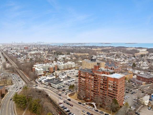 birds eye view of property with a water view and a view of city