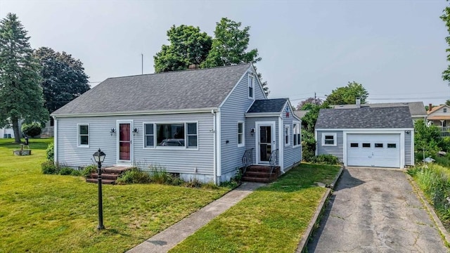 13 Meadow Ln, Acushnet, MA 02743 - cape cod house featuring an outbuilding, a shingled roof, asphalt driveway, a front yard, and a detached garage
