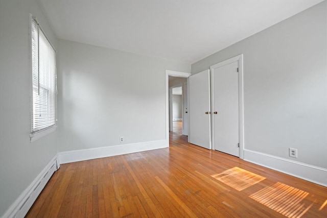 13 Meadow Ln, Acushnet, MA 02743 - unfurnished bedroom with a baseboard heating unit and wood-type flooring