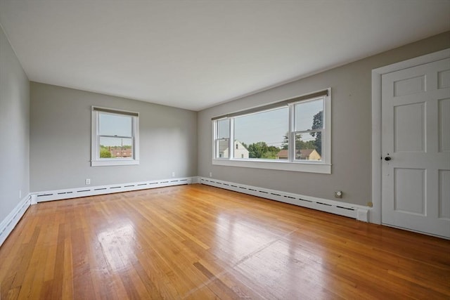 13 Meadow Ln, Acushnet, MA 02743 - empty room featuring plenty of natural light, hardwood / wood-style floors, and baseboard heating