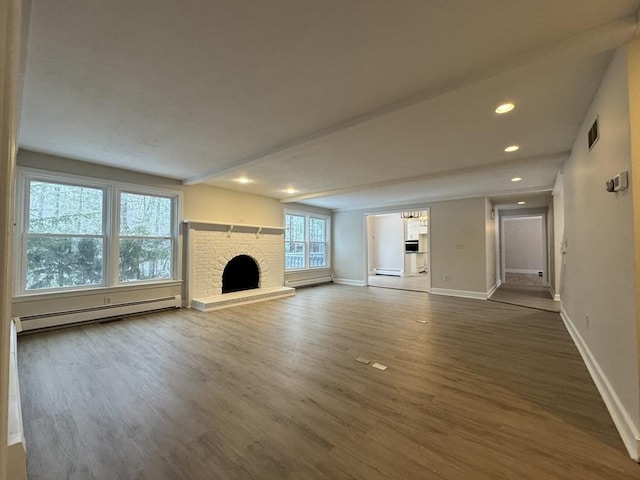 unfurnished living room featuring a baseboard radiator, a brick fireplace, and dark hardwood / wood-style floors