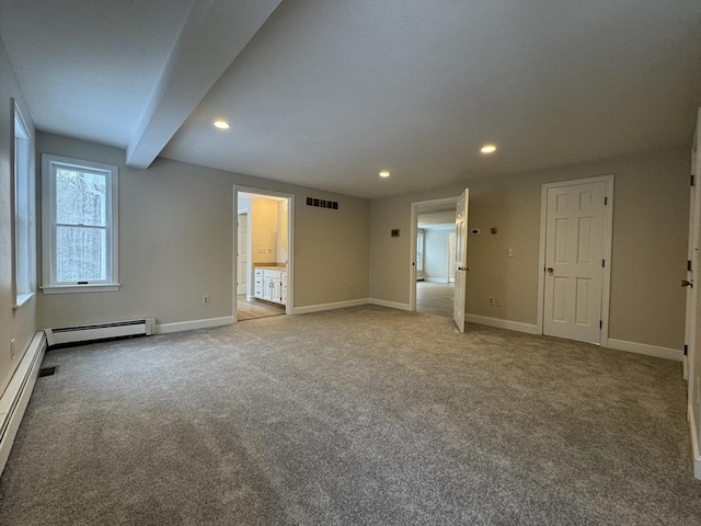 empty room featuring a baseboard radiator, light colored carpet, and beamed ceiling