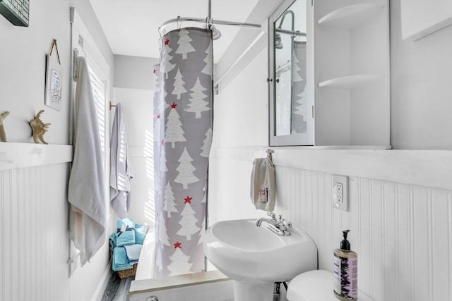 bathroom with sink, a shower, toilet, and hardwood / wood-style flooring