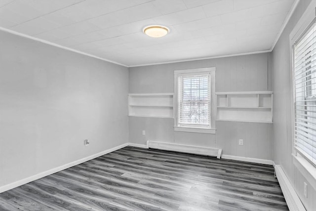 empty room featuring ornamental molding, dark hardwood / wood-style flooring, and a baseboard radiator