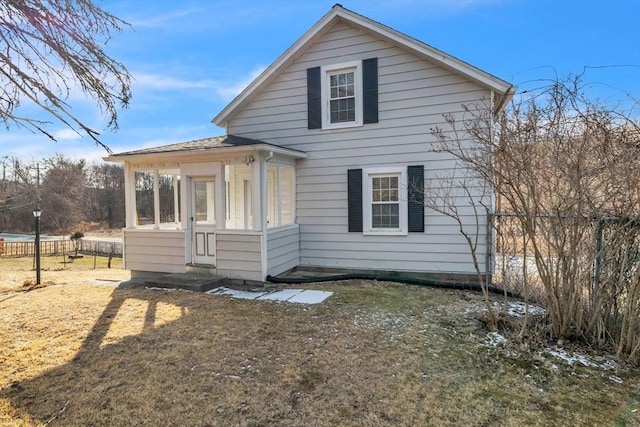 view of side of home with a yard