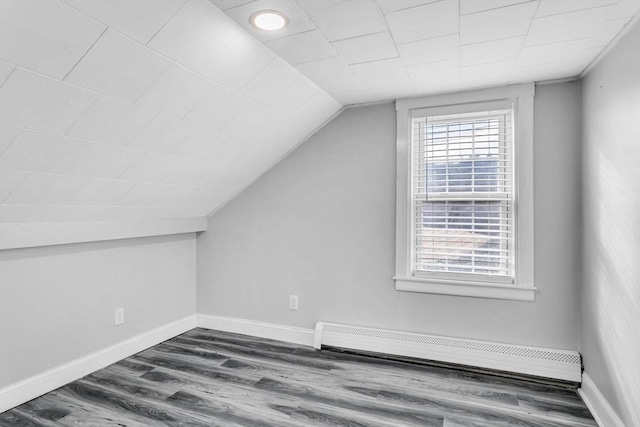 bonus room featuring lofted ceiling, a baseboard heating unit, and dark hardwood / wood-style floors