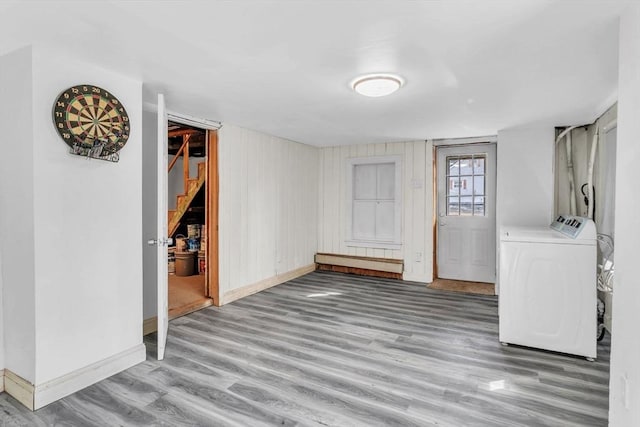 interior space featuring wood-type flooring and independent washer and dryer