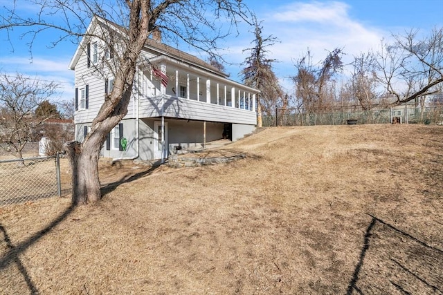 view of side of home featuring a sunroom