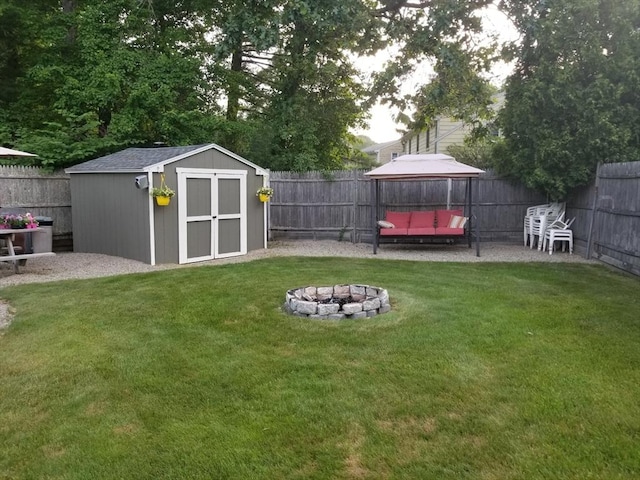 view of yard with a storage unit and a fire pit