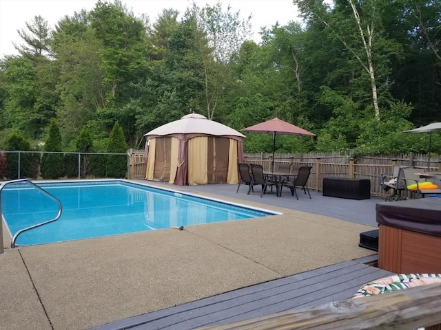 view of swimming pool featuring a hot tub, a patio area, and a gazebo