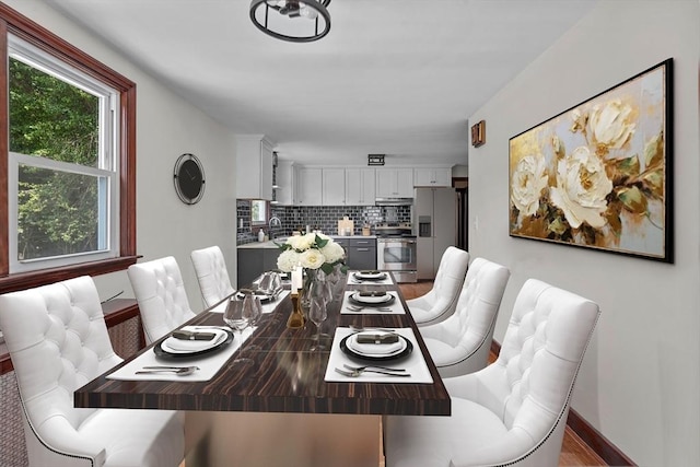 dining space with hardwood / wood-style floors