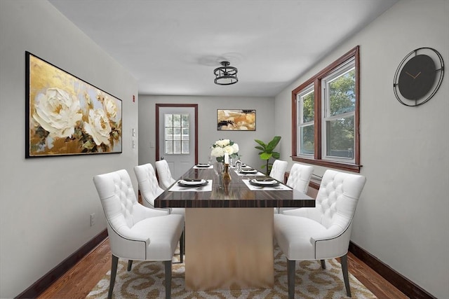 dining room featuring a healthy amount of sunlight and hardwood / wood-style floors