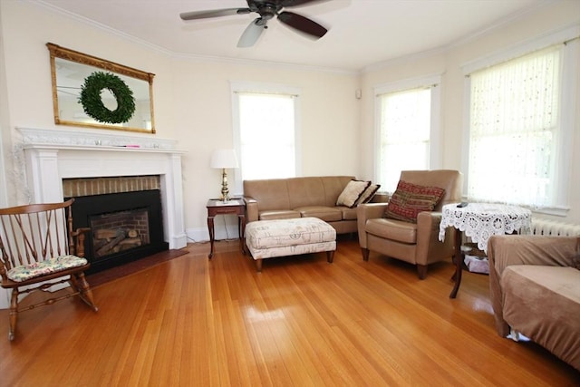 27 Summer St, Saugus, MA 01906 - living area featuring light wood-style floors, ceiling fan, a brick fireplace, and crown molding